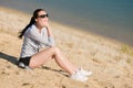 Summer sport fit woman sitting on beach Royalty Free Stock Photo