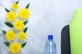 Summer spring flatlay composition yoga mat and bottle of water