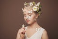 Summer or spring portrait of young beautiful nude makeup woman with healthy skin and white flowers looking at butterfly Royalty Free Stock Photo