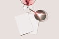 Summer stationery still life scene. Glass of red wine, cocktail, long shadow. Blank greeting cards mockups scene. Pink