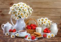 Summer still life, berries, milk and chamomile on an old board Royalty Free Stock Photo