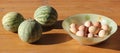 Three striped water-melons and eggs in a glass vas Royalty Free Stock Photo