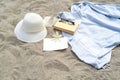 Summer still life. White straw hat on the sand of the mediterranean beach. Summer party invitation card mockup with white flower, Royalty Free Stock Photo