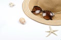 Summer straw hat, sunglasses, shells, starfish on white background