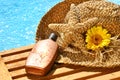 Summer straw hat with tanning lotion Royalty Free Stock Photo