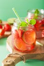 Summer strawberry drink with lime and mint in jars