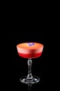 Summer strawberry margarita cocktail with violet flower isolated on a black background. Fresh alcoholic cocktail Royalty Free Stock Photo