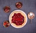 Summer strawberry pie cake galette and cooper saucer with strawberries over on gray background. Top view Royalty Free Stock Photo
