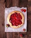 Summer strawberry pie cake galette and cooper saucer with strawberries over on gray background. Top view Royalty Free Stock Photo