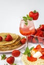 Summer strawberry season. Strawberries with pancakes and ice cream and Water with ice and strawberry syrup. Desserts Royalty Free Stock Photo