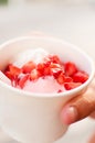 Summer street dessert, frozen yogurt with strawberries in a Cup, selective focus