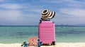 Summer stuff with Pink luggage on the white sand Beach background banner of the tropical travel concept Royalty Free Stock Photo