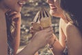 Summer style concept with couple of cheerful beautiful young women eating ice cream together in friendship - closeup of girls