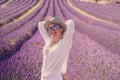 Summer style portrait of cute middle age woman smiling and having fun with violet flowers of lavender fields in background - Royalty Free Stock Photo