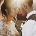 Summer sun shines over stunning wedding couple walking in lonely Georgian town