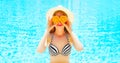 Summer sunny portrait woman holds in hands oranges hides his eyes Royalty Free Stock Photo