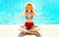 Summer sunny smiling woman holds in hands oranges and hides her eyes Royalty Free Stock Photo