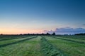 Summer sunrise over fresh hay on pasture Royalty Free Stock Photo