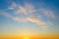 Summer sunrise sky with sunbeams and few golden translucent clouds. Beautiful dawn skyscape. Clear paradise sky at early morning. Royalty Free Stock Photo