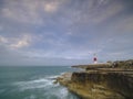 Summer sunrise with stormy clouds and slow shutter speed at Portland Bill Light, Dorset, UK Royalty Free Stock Photo