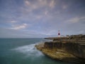 Summer sunrise with stormy clouds and slow shutter speed at Portland Bill Light, Dorset, UK Royalty Free Stock Photo