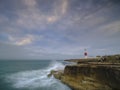 Summer sunrise with stormy clouds and slow shutter speed at Portland Bill Light, Dorset, UK Royalty Free Stock Photo