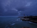 Summer sunrise with stormy clouds and slow shutter speed at Portland Bill Light, Dorset, UK Royalty Free Stock Photo