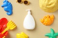 Summer sunscreen cream bottle mockup, sunglasses, sand molds, panama hat top view. Baby sun protection concept