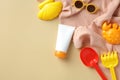 Summer sunscreen cream tube mockup, sunglasses, sand molds, towel top view. Baby sun protection concept