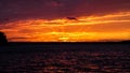 Summer sunset on the horizon across Minnesota lake