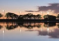 Summer sunset on the lake with clouds reflection