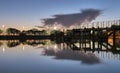 Summer sunset on the lake with clouds reflection