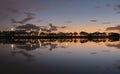 Summer sunset on the lake with clouds reflection