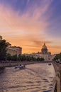 Summer sunset landscape of Saint Petersburg, Russia. Saint Isaac Cathedral across Moyka river. Pleasure boats on the Royalty Free Stock Photo