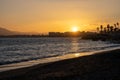 Summer sunset. Orange sky over the sea, beach with palm trees Royalty Free Stock Photo