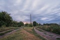 Summer sunset over field and road near the town Royalty Free Stock Photo