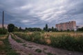 Summer sunset over field and road near the town Royalty Free Stock Photo