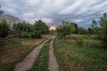 Summer sunset over field and road near the town Royalty Free Stock Photo