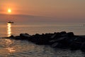 Summer sunset over the sea. Boat and stones Royalty Free Stock Photo