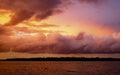 Pink colored cumulus cloud, sunset seascape. Royalty Free Stock Photo