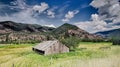 Summer sunset with a red barn in rural Montana and Rocky Mountains Royalty Free Stock Photo