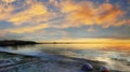 Summer Sunset at sea pink cloudy sky gold orange skyline seascape on horizon, seashell on beach stone romantic view on Baltic S