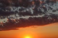 Summer sunset sky with orange and dark blue clouds Royalty Free Stock Photo