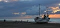 Summer sunset at Slettestrand, Denmark. Fishing boat on the beach.