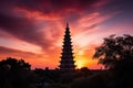 summer sunset, with view of the majestic pagoda against a vibrant pink sky