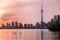 Summer sunset view from Toronto Islands across the Inner Harbour of the Lake Ontario on Downtown Toronto skyline with Royalty Free Stock Photo