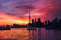 Summer sunset view from Toronto Islands across the Inner Harbour of the Lake Ontario with water taxi boat in foreground and Royalty Free Stock Photo