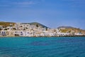 Summer sunshine over Naoussa town, Paros island, Greece. Clear blue sky, sea waters, whitewashed town by waterfront. Royalty Free Stock Photo