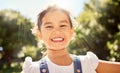 Summer, sunshine and portrait of Asian child in the park smile on face, playing and enjoying nature. Happiness, joy and Royalty Free Stock Photo