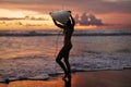 Summer. Surfer girl silhouette with surf board on sunset beach Royalty Free Stock Photo